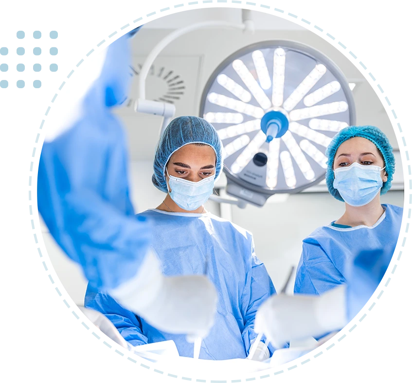 Group of surgeons wearing safety masks performing operation.